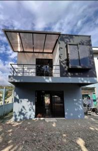 a house with a large window and a balcony at Cat’onas apatment in Nicoya