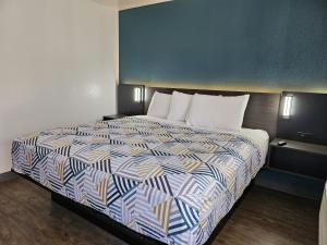 a bed in a hotel room with a large bed at Motel 6-Westminster, CA - North in Westminster