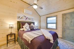 a bedroom with a bed in a log cabin at Cozy Broken Bow Cabin Fire Pits, Community Spaces in Broken Bow