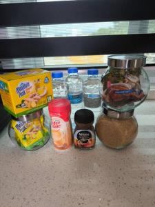 a counter top with a jar of food and other ingredients at KC suites in Government Pen