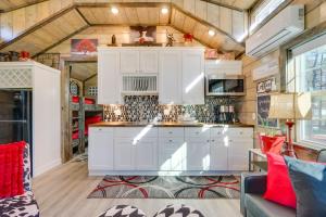 a kitchen in a tiny house with white cabinets at Pet-Friendly Broken Bow Cabin Hot Tub and Fireplace in Broken Bow