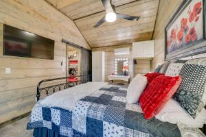 a bedroom with a bed and a ceiling fan at Pet-Friendly Broken Bow Cabin Hot Tub and Fireplace in Broken Bow