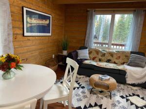 Cozy Alaskan Log Home - Aurora overhead في فيربانكس: غرفة معيشة مع أريكة وطاولة