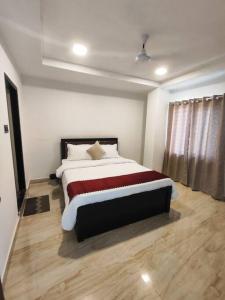 a bedroom with a large bed in a room at Lily Homes in Guwahati