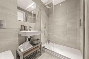 a bathroom with a sink and a shower and a toilet at Atlas House Three in Harrogate