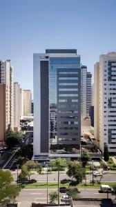 a large tall building in a city with buildings at Studio Helbor Stay Batel - Aconchegante com Vista e Localização Privilegiada in Curitiba