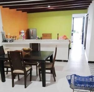 a kitchen and dining room with a table and chairs at Finca Eccehomo in San Luis