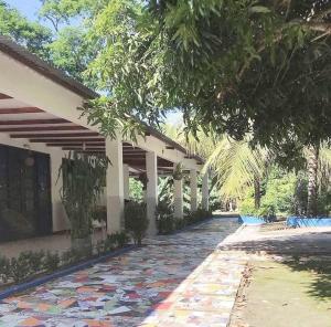 a building with a walkway with colorful tiles on it at Finca Eccehomo in San Luis