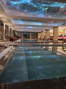 a swimming pool in a building with a star ceiling at Ivkovic spa Milmari N16 in Kopaonik