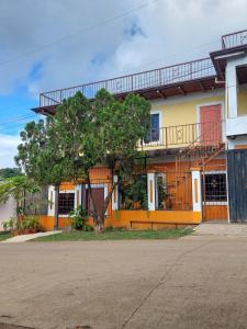 a building with a tree in front of it at Hotel Princess Inn in Agua Azul