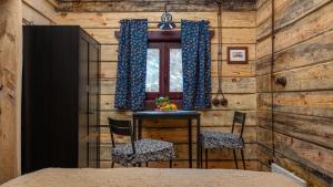 a room with a table and two chairs and a window at Chalet Mountain Deer in Kolašin