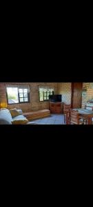 a room with two beds and a television in it at Sobrado com vista profissional do mar in Arroio do Sal