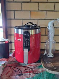 a red appliance sitting on top of a table at Sobrado com vista profissional do mar in Arroio do Sal