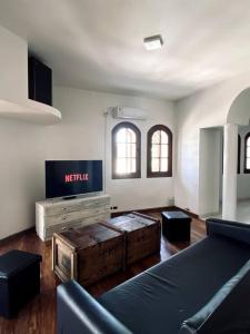 a living room with a couch and a tv at B61 house in Concordia