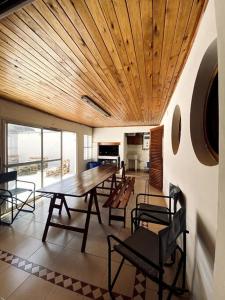 a dining room with a wooden table and chairs at B61 house in Concordia