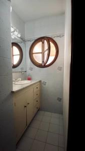 a bathroom with a sink and a round window at B61 house in Concordia