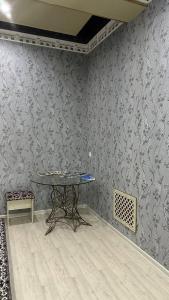 a table in a room with a wall at La Inspira in Samarkand