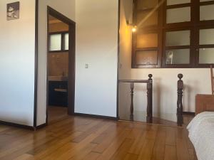 a bedroom with a door and a wooden floor at Sea Breeze - BeachHouse in Mindelo