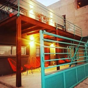 a room with red chairs and a bunk bed at Raíces in Puerto Pirámides