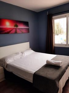 a bedroom with a white bed and a window at Villa Cambrils Mar in Cambrils