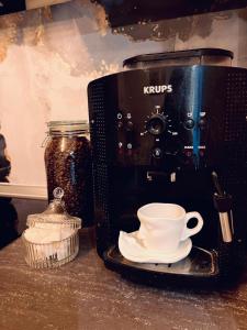 a coffee maker and a cup on a counter at Alpine Escape by BOB in Cavnic +8 photos