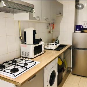 a kitchen with a stove and a microwave on a counter at Appartement charonne in Paris