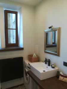 a bathroom with a white sink and a mirror at Art Illery Apartment in Riga