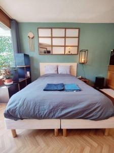 een slaapkamer met een groot bed met blauwe lakens bij Appartement ski in out 5 in Les Houches
