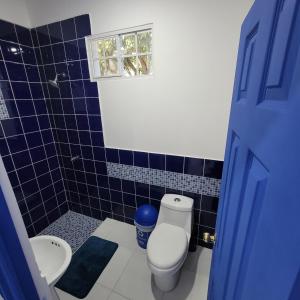 Baño de azulejos azules con aseo y lavamanos en RANCHO SARIMAR, en La Libertad