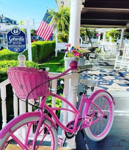 a pink bike parked next to a fence at The Grenville Hotel and Restaurant in Bay Head