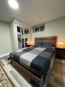 a bedroom with a large bed and two lamps at Niagara Falls BNB 15 mins away from Falls in Thorold
