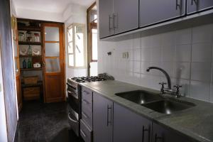 a kitchen with a sink and a stove at M Pugliese Amplio, cómodo y luminoso a metros del subte in Buenos Aires