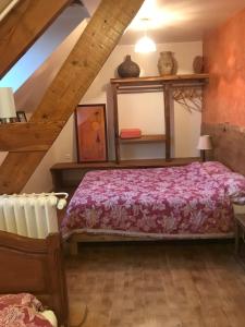 a bedroom with a bed in a attic at La Nesliere Chambres d'Hôtes Bio in Saint-Symphorien-des-Monts +16 photos