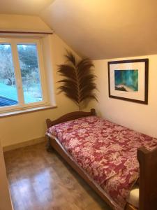 a bedroom with a bed and a window at La Nesliere Chambres d'Hôtes Bio in Saint-Symphorien-des-Monts