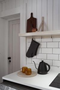 a kitchen counter with a tea pot and a tea kettle at Pieprz & Sól FARMHOUSES in Załuczne