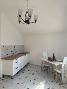 a kitchen with a table and a white counter and a table at La Terrazza in Dobra Voda
