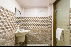 a bathroom with a sink and a shower at The New Lord Krishna @ New Delhi Railway station in New Delhi
