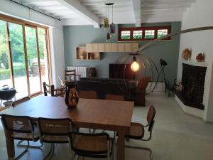 a dining room with a table and chairs and a fireplace at Villa Bagno Santo in Sarteano