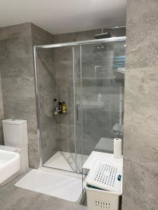 een badkamer met een douche, een toilet en een wastafel bij Sea City Torremolinos Golf in Torremolinos