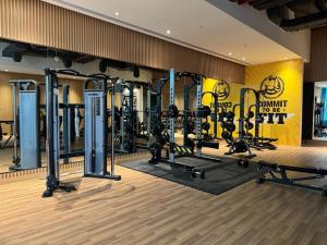 a gym with lots of equipment in a room at Beachside Bliss: Stylish New Studio at Seven Palm in Dubai