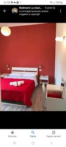 a red bedroom with a bed with a red wall at Bedroom la stazione in Palermo
