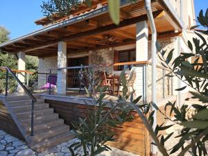a house with a staircase leading to a patio at Apartman More in Lun