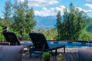 a patio with two chairs and a swimming pool at AzulZenLodge in Paine
