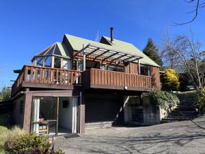a large house with a deck on top of it at 90 Chalet Crescent in Hanmer Springs