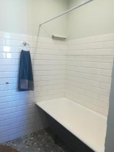 a bathroom with a bath tub and a towel at Art Illery Apartment in Rīga