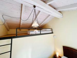 a chandelier hanging from a ceiling in a room at Casa Mina(Wi-fi & TV) in Serralunga di Crea +11 photos