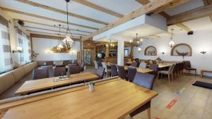 a dining room with wooden tables and chairs at Fürstensteiner Hof in Fürstenstein