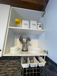 a cupboard with dishes and utensils in it at Barbarosa 6 Königstädten Opel-Airport-Messe nähe in Königstädten