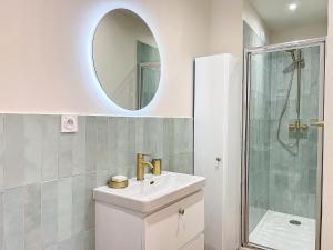 La salle de bains blanche est pourvue d'un lavabo et d'un miroir. dans l'établissement Charmant Appartement - Avec Balcon & Lumineux - Les Frères de la Loc', à Marseille