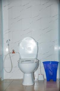 a white bathroom with a toilet and a shower at Mafia Neptune Villa Lodge in Utende